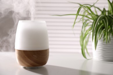 Photo of One stylish aroma lamp on white table indoors, closeup. Space for text