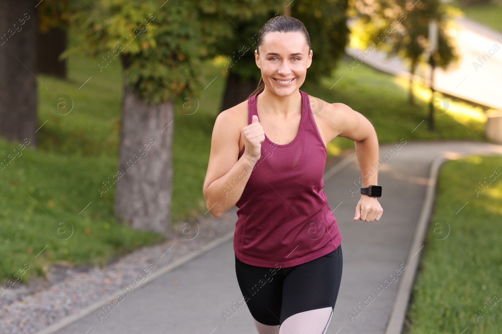 Athletic young woman in sportswear running outdoors, space for text Photo of Athletic young woman in sportswear running outdoors, space for text