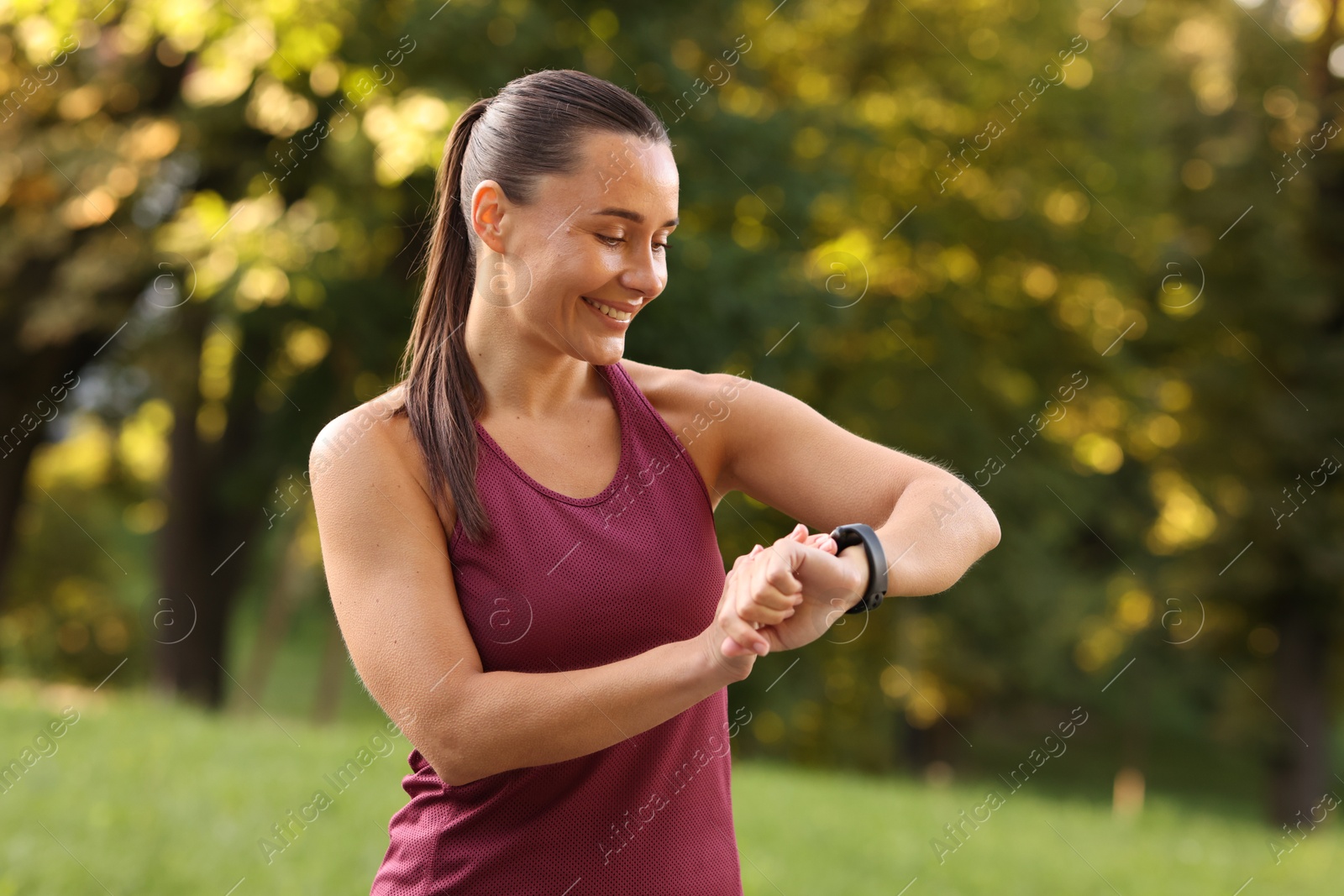 Athletic young woman checking fitness tracker before running outdoors Photo of Athletic young woman checking fitness tracker before running outdoors
