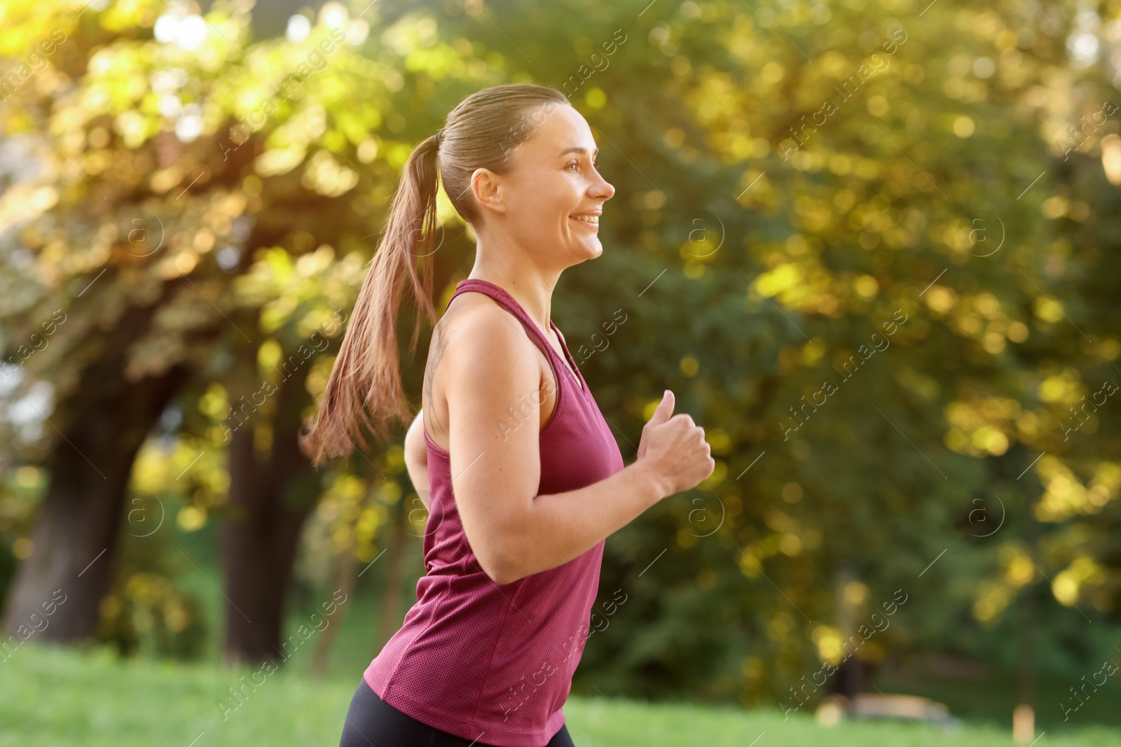 Athletic young woman in sportswear running outdoors Photo of Athletic young woman in sportswear running outdoors