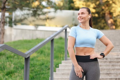 Photo of Athletic young woman in sportswear before running outdoors, space for text