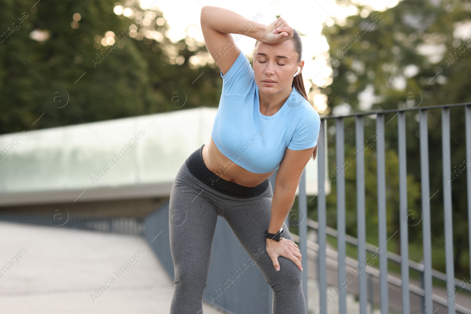 Athletic young woman in sportswear before running outdoors Photo of Athletic young woman in sportswear before running outdoors