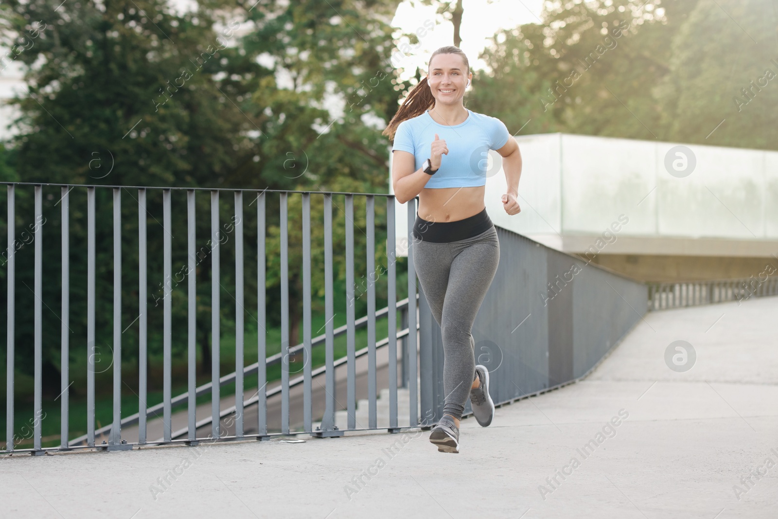 Athletic young woman in sportswear running outdoors Photo of Athletic young woman in sportswear running outdoors