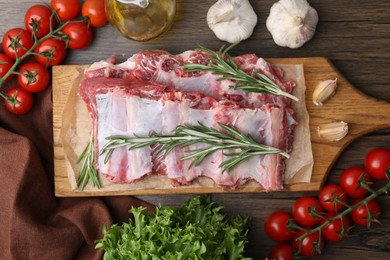 Photo of Fresh raw beef ribs and ingredients on wooden table, flat lay