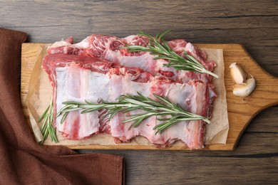 Photo of Fresh raw beef ribs and spices on wooden table, top view