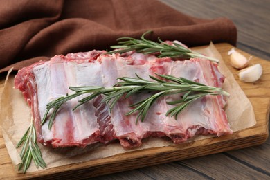 Photo of Fresh raw beef ribs and spices on wooden table, closeup