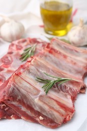 Photo of Fresh raw beef ribs and spices on table, closeup