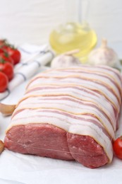 Photo of Piece of raw beef meat, tomatoes and spices on table, closeup