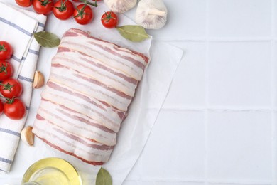 Photo of Piece of raw beef meat, tomatoes and spices on white tiled table, flat lay. Space for text
