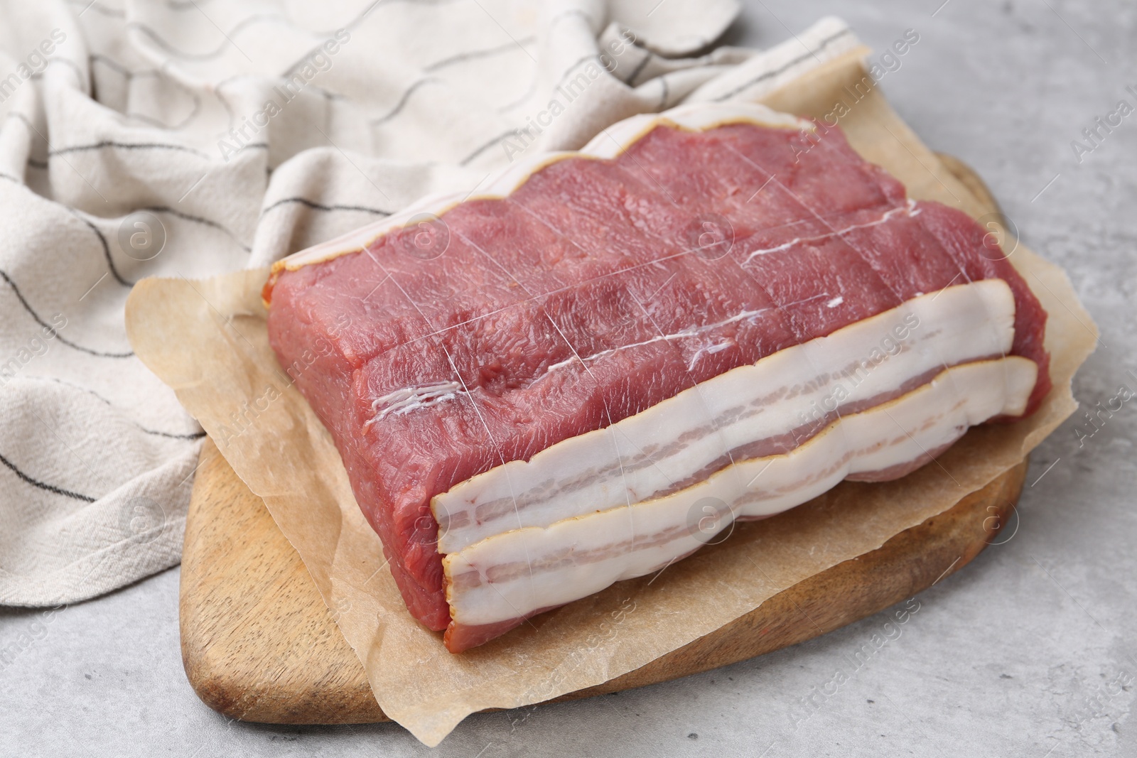 Piece of raw beef meat on grey table, closeup Photo of Piece of raw beef meat on grey table, closeup