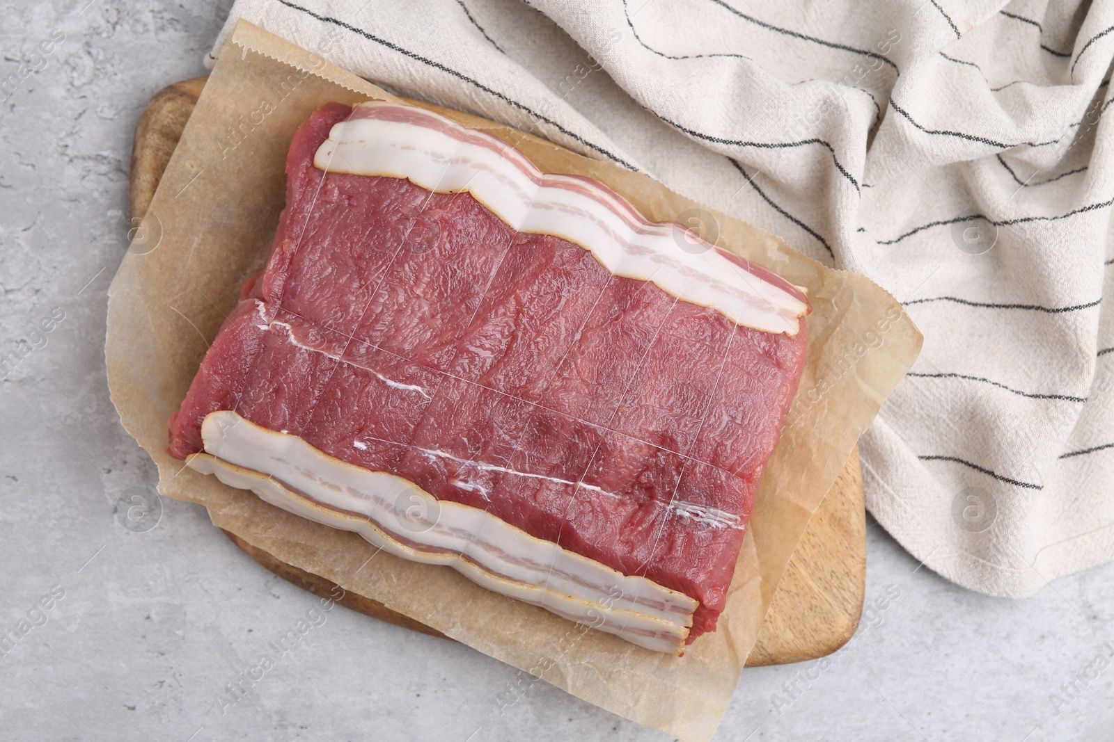 Piece of raw beef meat on grey table, top view Photo of Piece of raw beef meat on grey table, top view