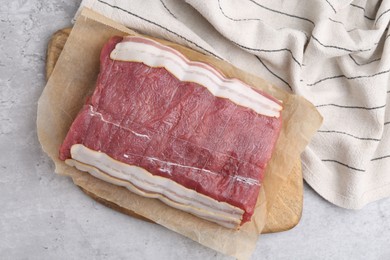 Photo of Piece of raw beef meat on grey table, top view