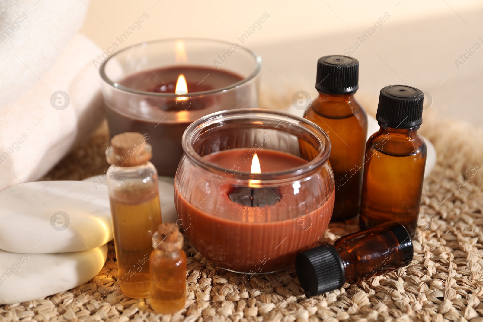 Spa composition with burning candles on table against beige background, closeup Photo of Spa composition with burning candles on table against beige background, closeup