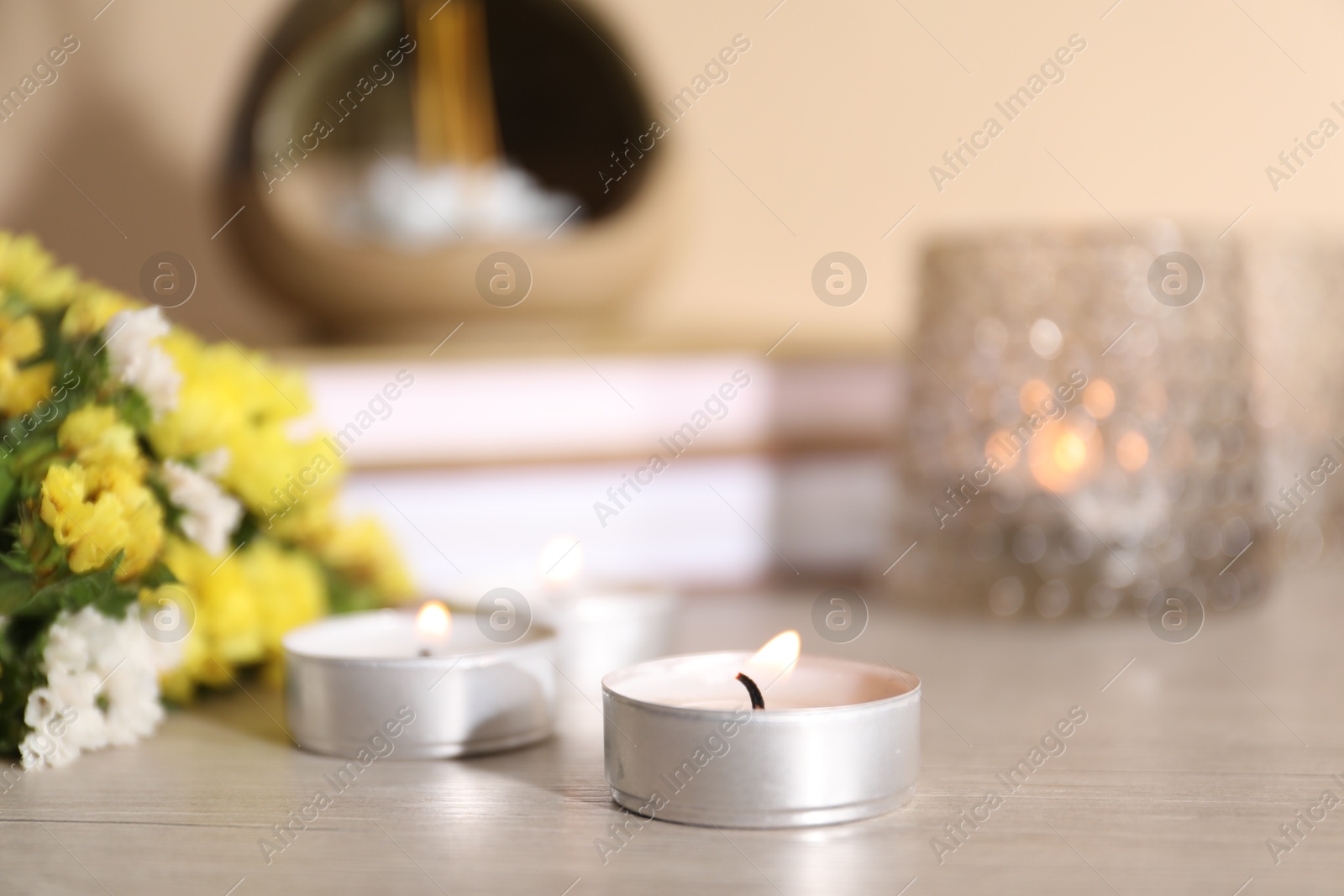 Spa composition with burning candles on wooden table against beige background, closeup Photo of Spa composition with burning candles on wooden table against beige background, closeup