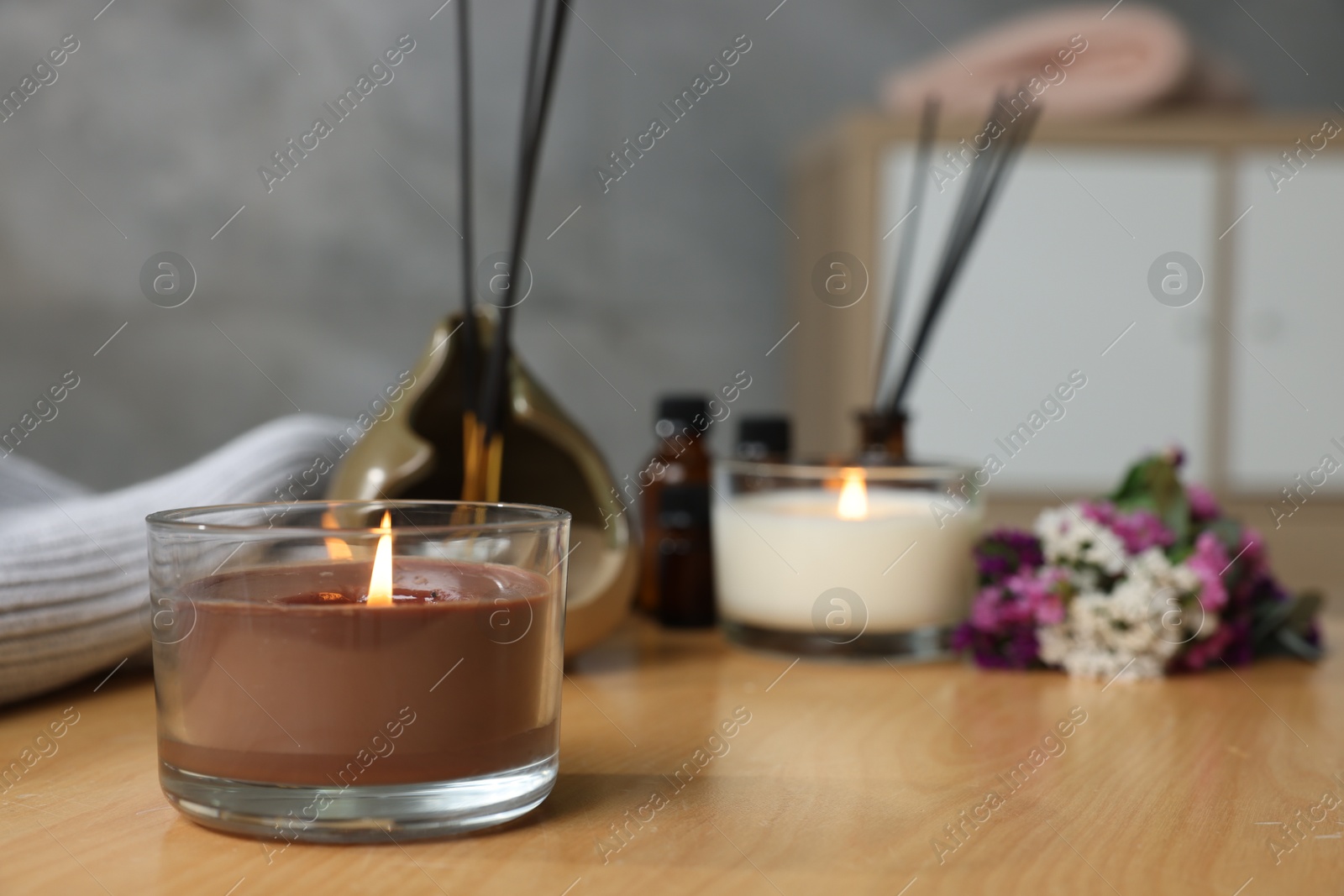 Spa composition with burning candles on wooden table indoors, closeup Photo of Spa composition with burning candles on wooden table indoors, closeup