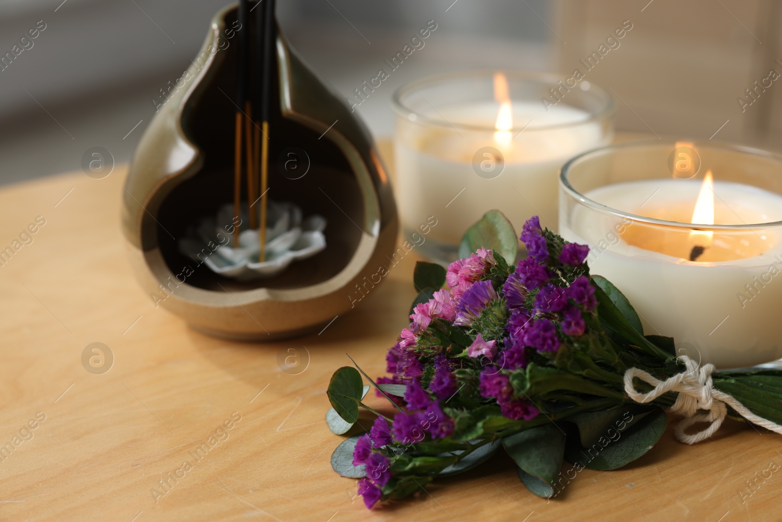 Spa composition with burning candles on wooden table indoors, closeup Photo of Spa composition with burning candles on wooden table indoors, closeup