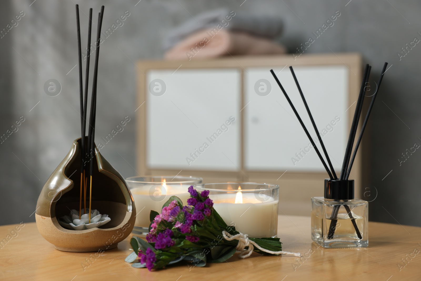 Spa composition with burning candles on wooden table indoors, closeup Photo of Spa composition with burning candles on wooden table indoors, closeup