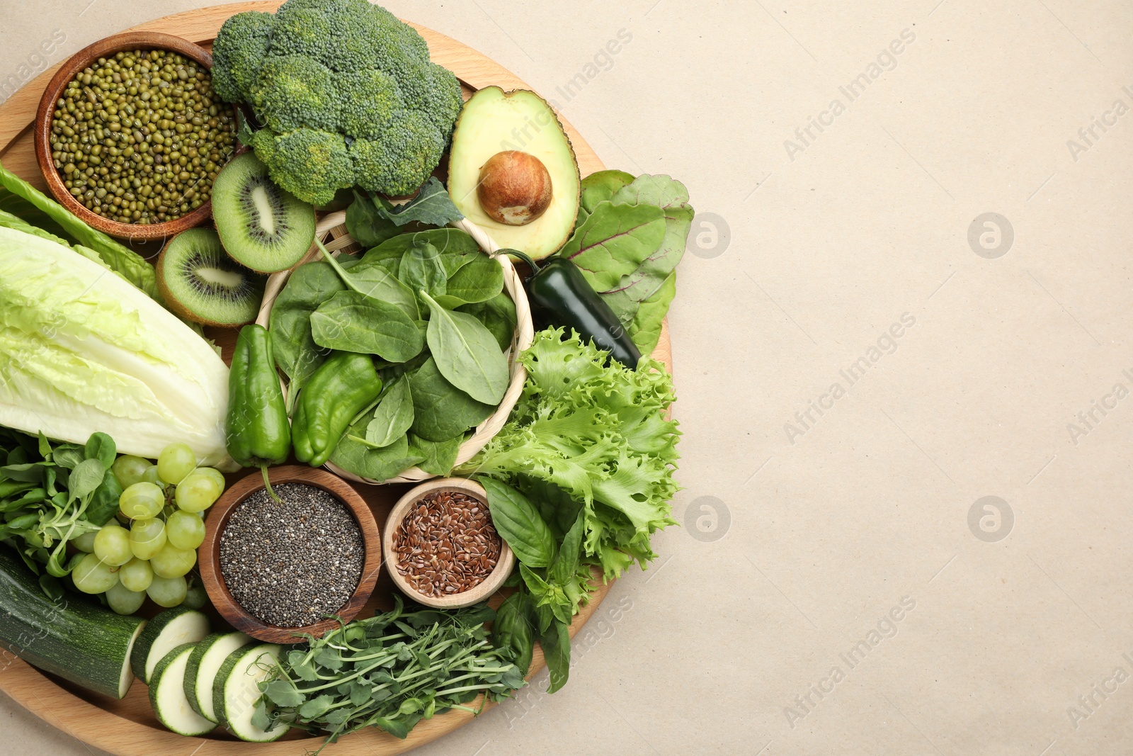 Superfood. Different healthy products on beige background, top view. Space for text Photo of Superfood. Different healthy products on beige background, top view. Space for text