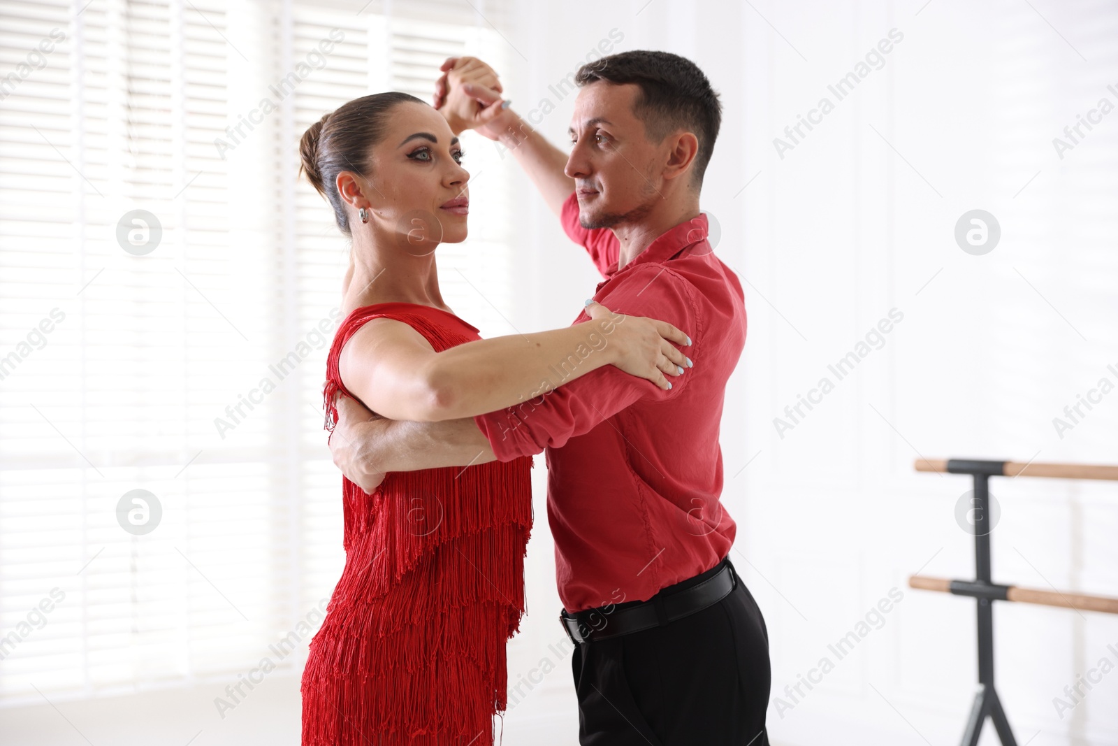 Couple of professional dancers training in studio Photo of Couple of professional dancers training in studio