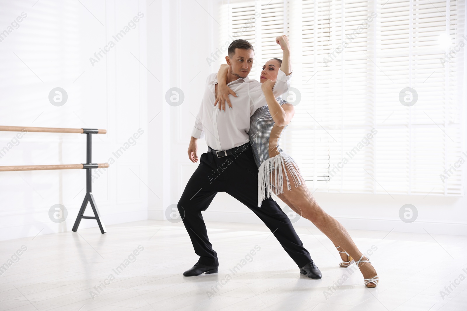 Couple of professional dancers training in studio Photo of Couple of professional dancers training in studio