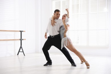 Photo of Couple of professional dancers training in studio