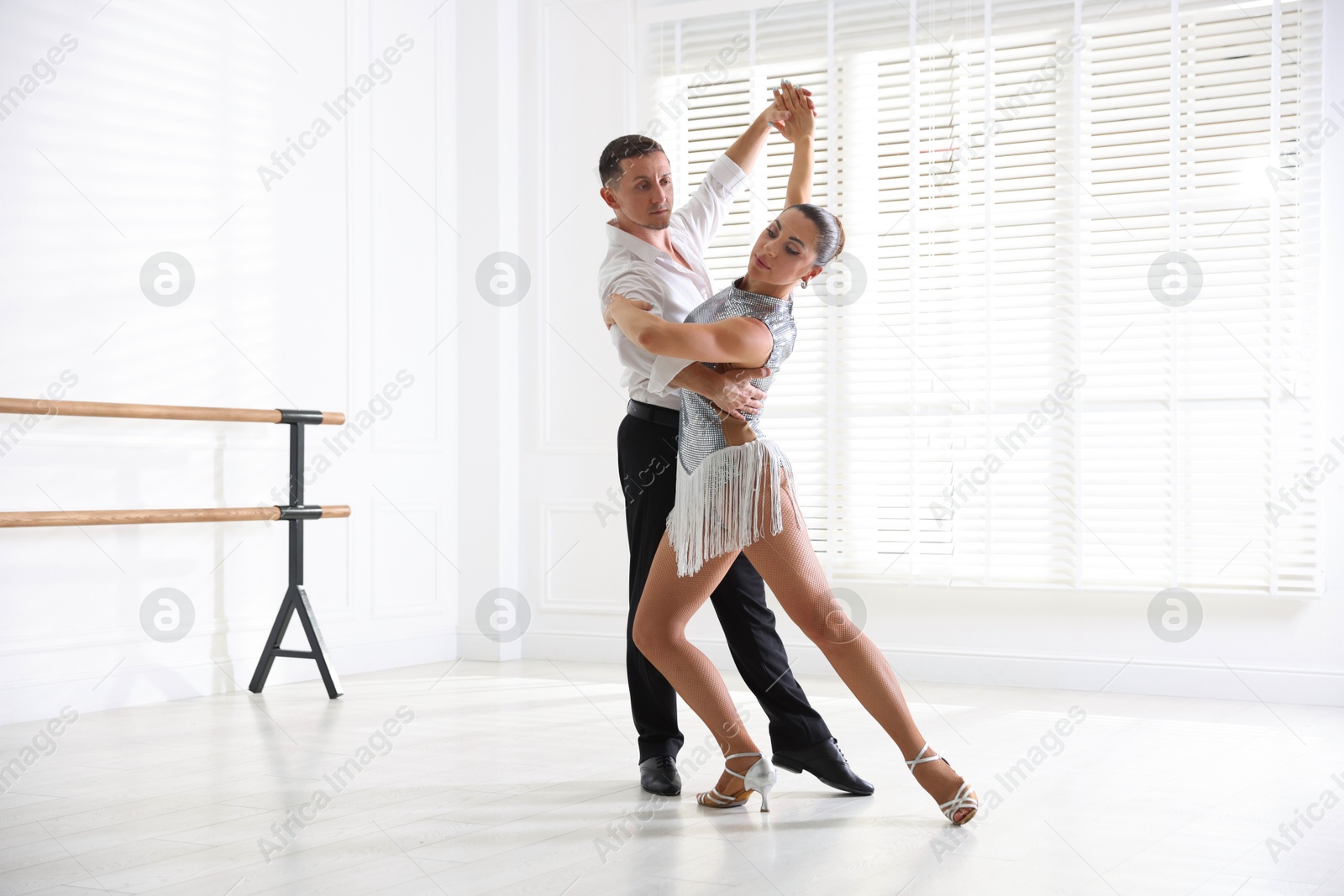 Couple of professional dancers training in studio Photo of Couple of professional dancers training in studio