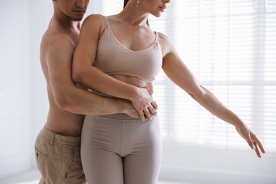 Photo of Couple of professional dancers training in studio, closeup