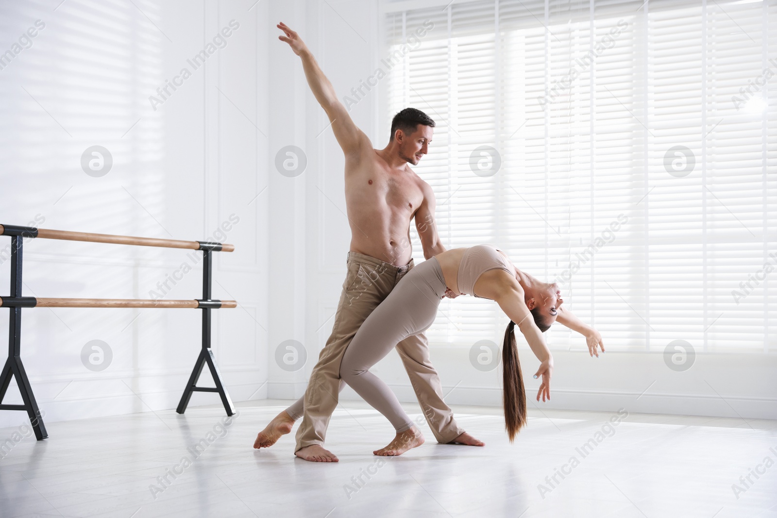 Couple of professional dancers training in studio Photo of Couple of professional dancers training in studio