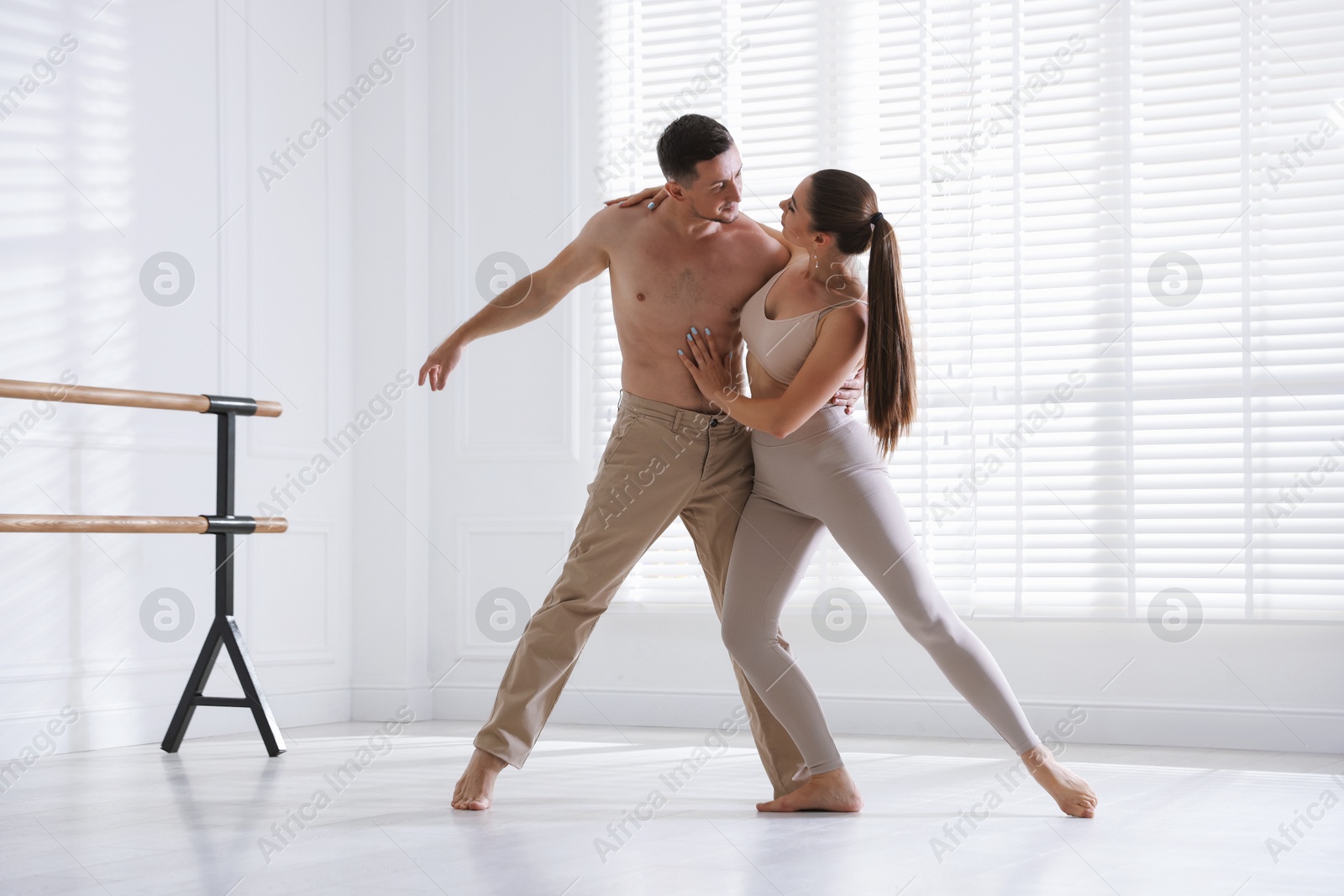 Couple of professional dancers training in studio Photo of Couple of professional dancers training in studio