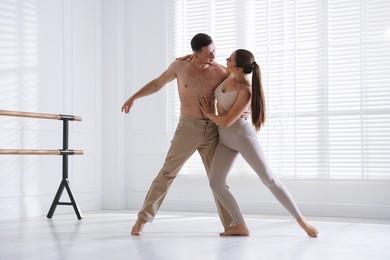 Photo of Couple of professional dancers training in studio