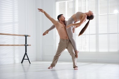 Photo of Couple of professional dancers training in studio