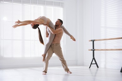 Photo of Couple of professional dancers training in studio
