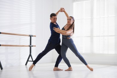 Photo of Couple of professional dancers training in studio
