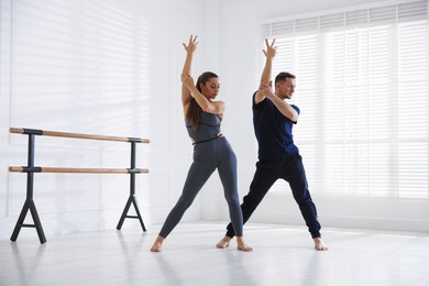 Photo of Couple of professional dancers training in studio