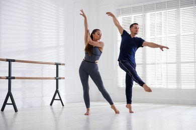 Photo of Couple of professional dancers training in studio