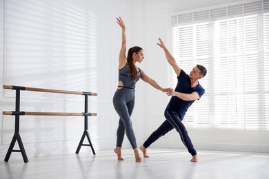 Photo of Couple of professional dancers training in studio
