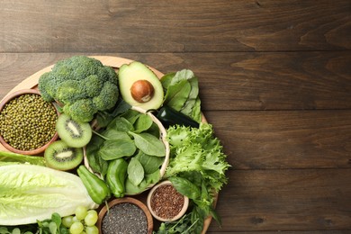 Photo of Superfood. Different healthy products on wooden table, top view. Space for text