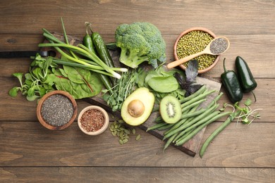 Photo of Superfood. Different healthy products on wooden table, flat lay