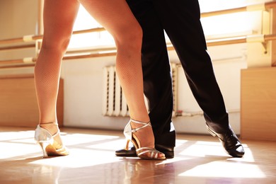 Photo of Couple of professional dancers training in studio, closeup