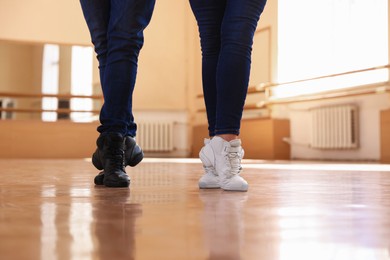 Photo of Couple of professional dancers training in studio, closeup