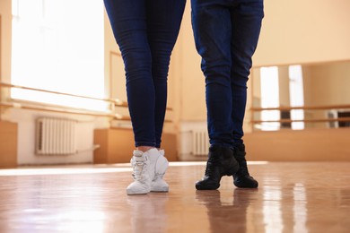 Photo of Couple of professional dancers training in studio, closeup