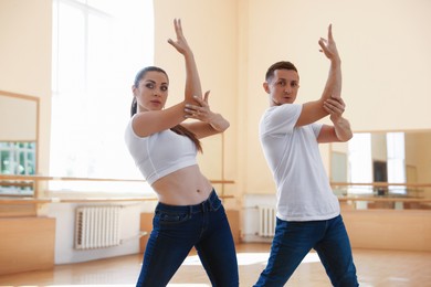 Photo of Couple of professional dancers training in studio