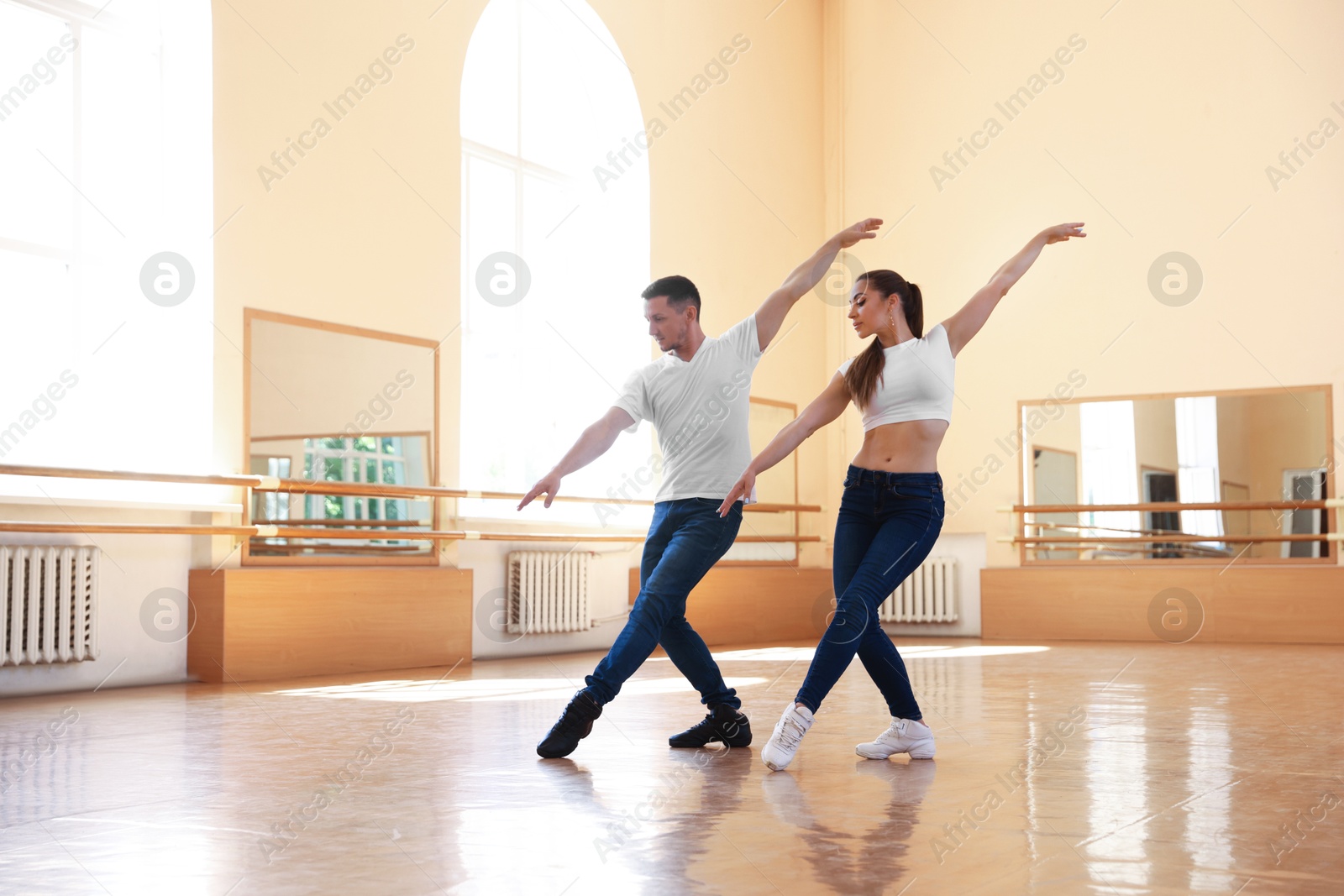 Couple of professional dancers training in studio Photo of Couple of professional dancers training in studio