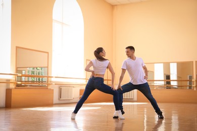 Photo of Couple of professional dancers training in studio