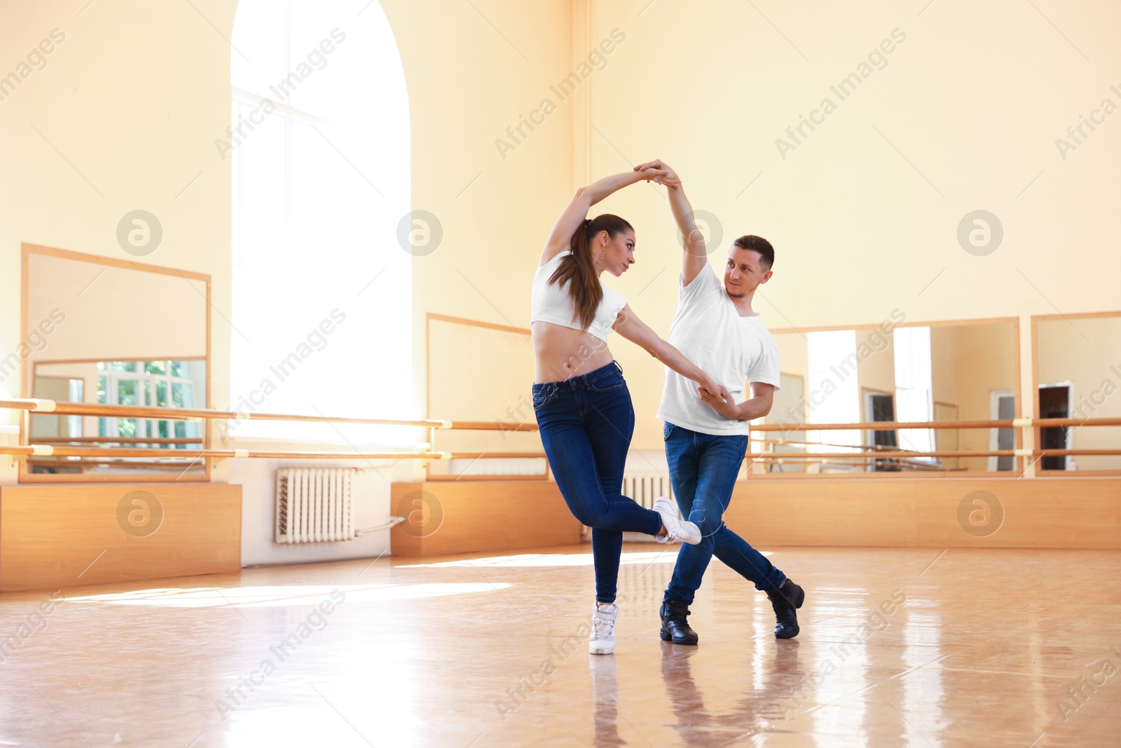 Couple of professional dancers training in studio Photo of Couple of professional dancers training in studio