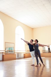 Photo of Couple of professional dancers training in studio