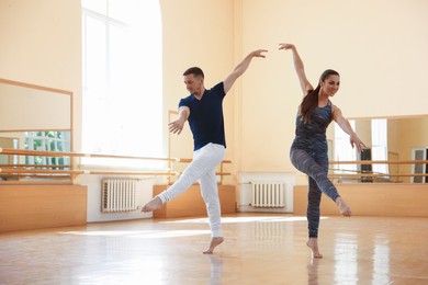 Photo of Couple of professional dancers training in studio