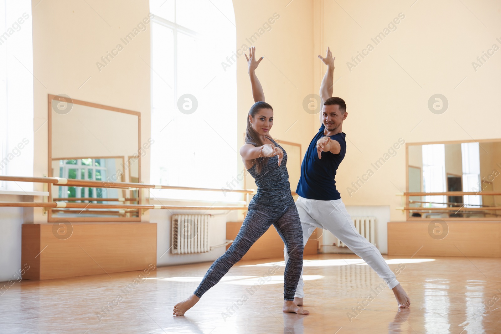 Couple of professional dancers training in studio Photo of Couple of professional dancers training in studio