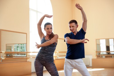 Photo of Couple of professional dancers training in studio