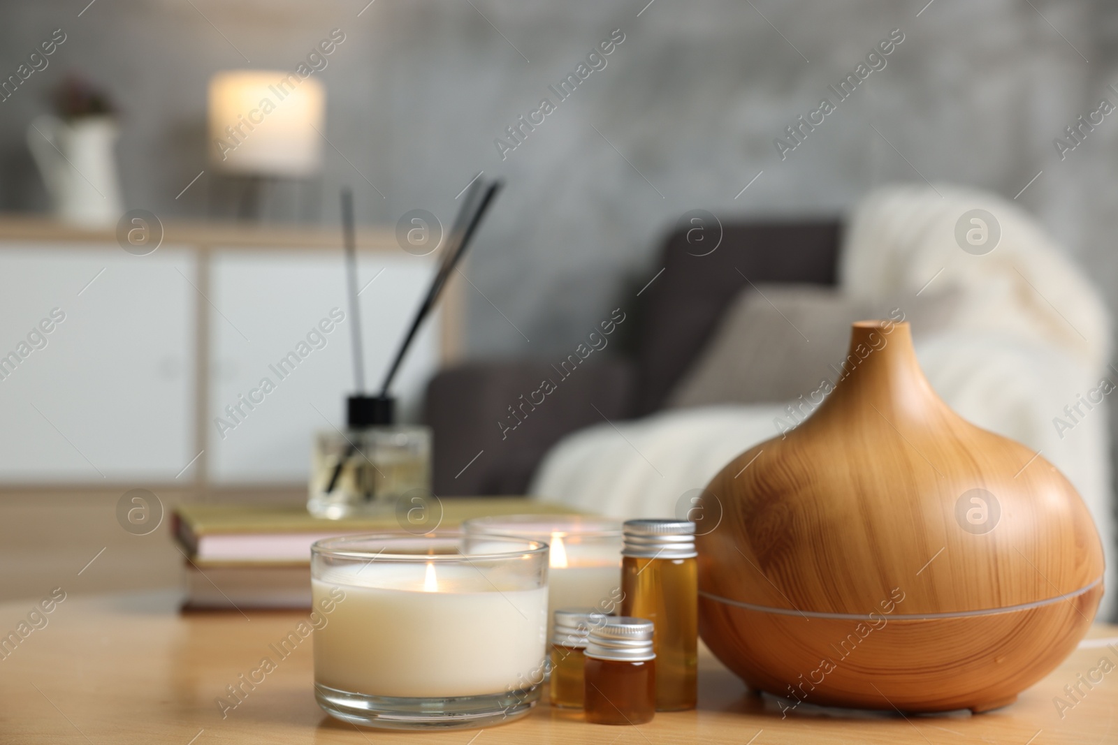 Spa composition with burning candles on wooden table indoors, closeup Photo of Spa composition with burning candles on wooden table indoors, closeup